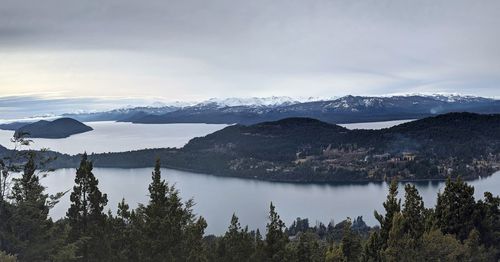 Scenic view of lake and mountains against sky