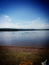 Scenic view of lake against cloudy sky