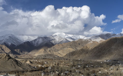 Beautiful landscape of mountains with sun over them in ladakh. captured during snowfall.