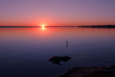 Scenic view of sea against romantic sky at sunset