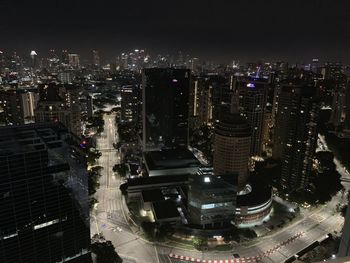 High angle view of illuminated buildings in city at night