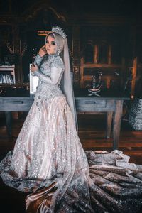 Portrait of bride wearing traditional clothing standing indoors