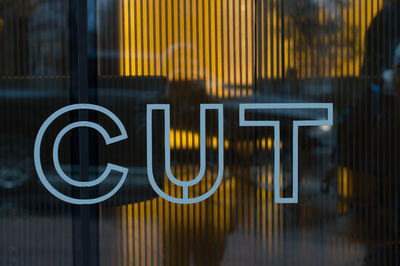 Close-up of cut text on glass