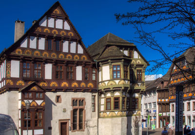 Low angle view of buildings against blue sky