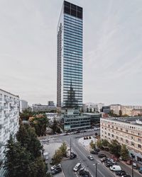View of city street and buildings against sky