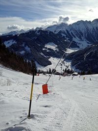 Overhead cable car over snowcapped mountains against sky