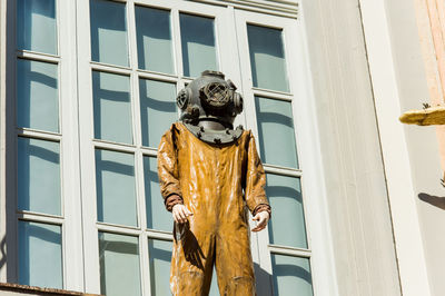 Low angle view of statue against building