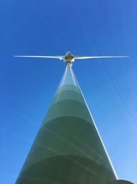 Low angle view of windmill against blue sky