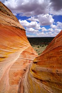 Scenic view of rock formations against cloudy sky