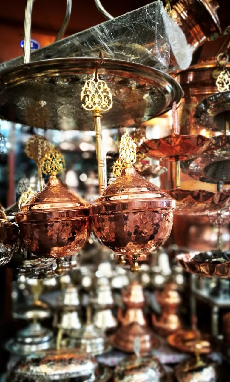 glass - material, hanging, focus on foreground, indoors, close-up, no people, transparent, lighting equipment, reflection, decoration, still life, business, glass, for sale, illuminated, retail, antique, shiny, store, market, electric lamp