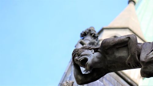 Low angle view of statue against blue sky viking cathedral nidarosdomen trondheim