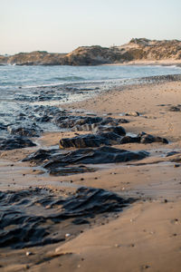 Surface level of beach against sky