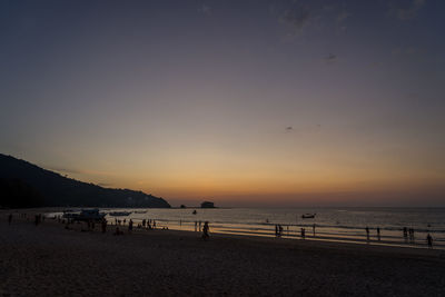 Scenic view of beach against sky during sunset