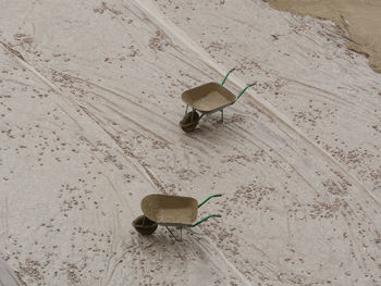 High angle view of wheelbarrows at construction site