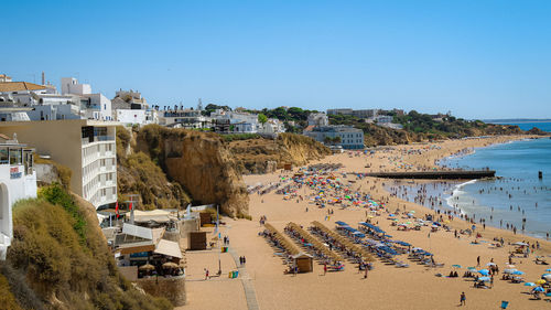 High angle view of beach and buildings against clear sky