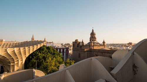 Panoramic view of buildings in seville against clear sky