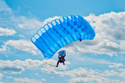 Person paragliding against sky