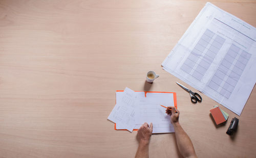 High angle view of woman working on paper