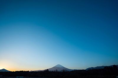 Scenic view of mountains against clear blue sky