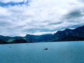 Scenic view of sea against cloudy sky