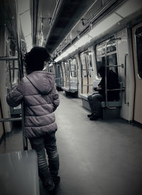 Rear view of man in train