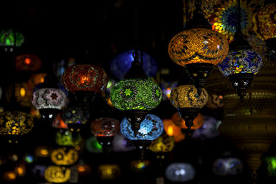 Close-up of illuminated lanterns hanging for sale