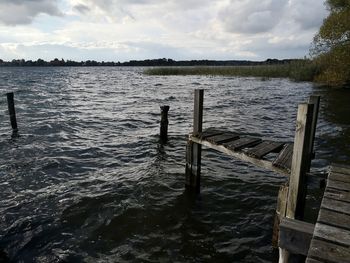 Pier over lake against sky