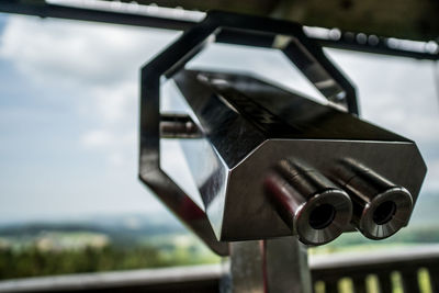 Close-up of metal railing against sky