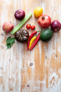 Various fruits and vegetables on light wooden background