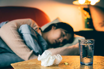 Midsection of woman sleeping on table