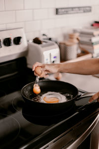 Midsection of man preparing food in kitchen at home