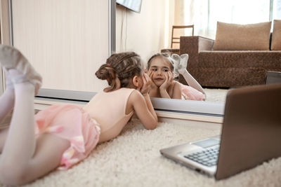 Girl lying down by mirror at home