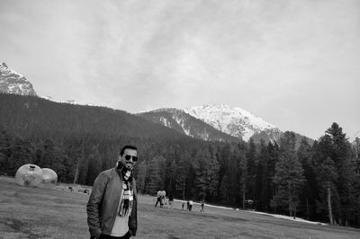 Man standing on mountain against sky