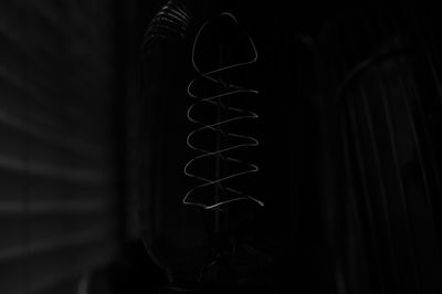 Close-up of electric lamp against black background