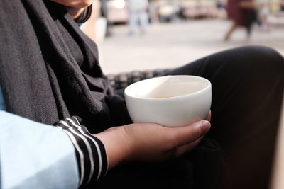 Close-up of hand holding coffee cup