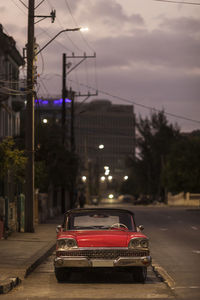 Cars on street in city at dusk