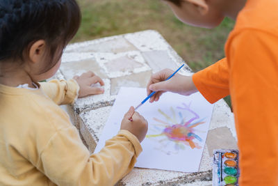 Cute kids painting outdoors