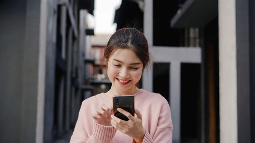 Portrait of smiling man using mobile phone