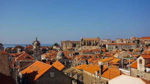 Houses in town against clear sky