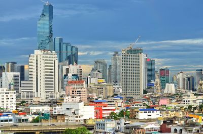 Cityscape against cloudy sky