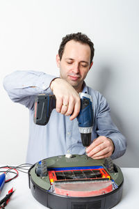 Portrait of smiling man holding camera