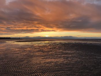 Scenic view of beach against sky during sunset