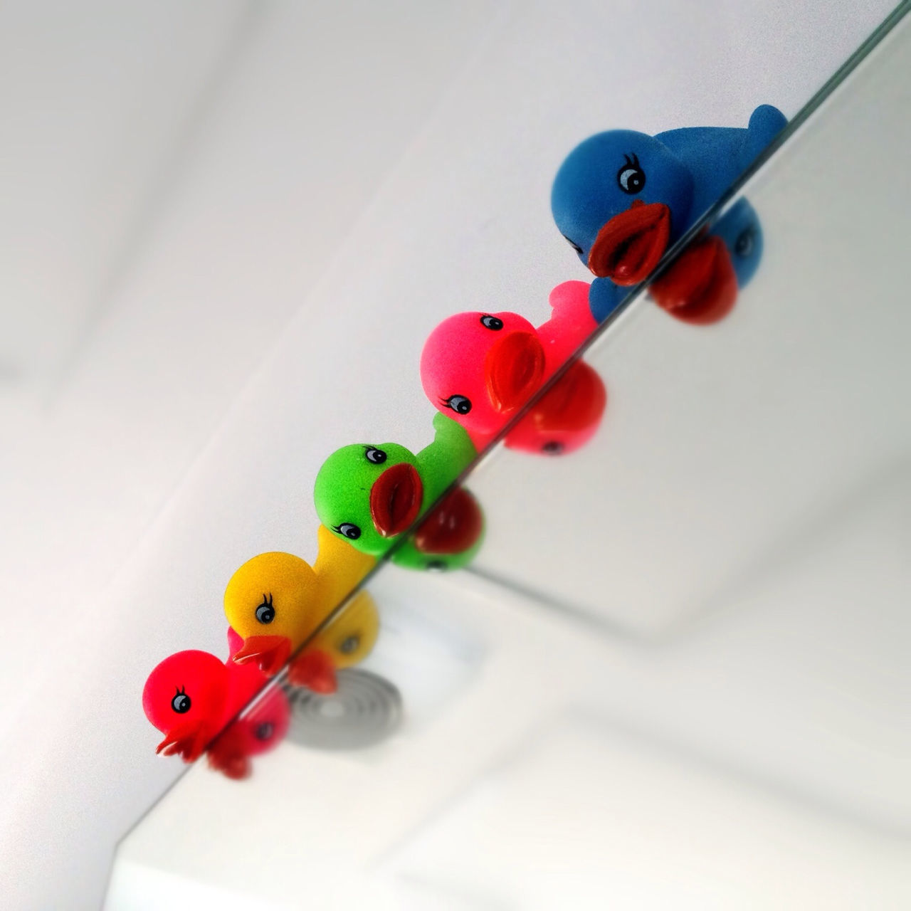 indoors, still life, toy, multi colored, table, red, childhood, animal representation, close-up, wall - building feature, no people, high angle view, variation, decoration, plastic, balloon, home interior, blue, creativity, art and craft