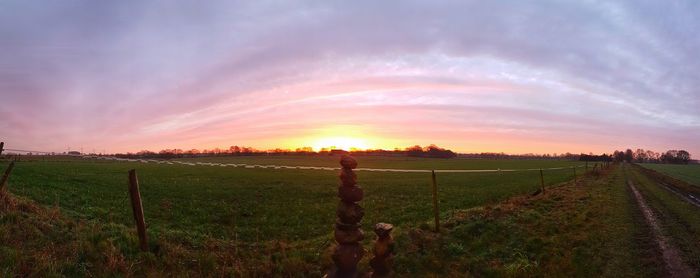 Scenic view of field against sky during sunset