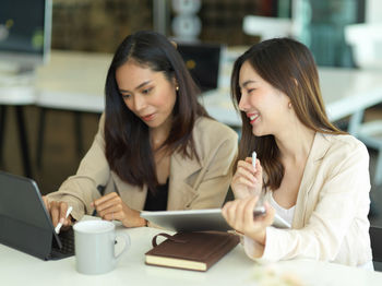 Young businesswomen brainstorming at office