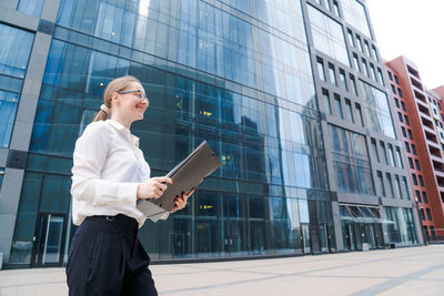 Business caucasian woman holding paper folder file smiling and feeling