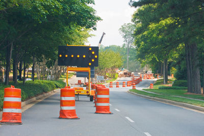 Road sign by cars on street in city