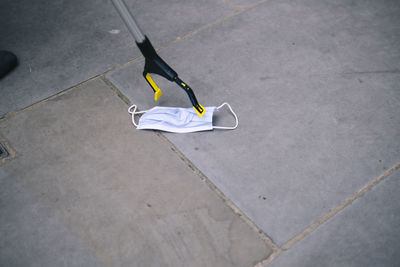 Protective face mask litter and waste picker on footpath