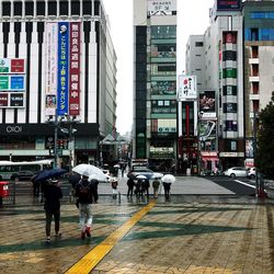 People walking on road in city