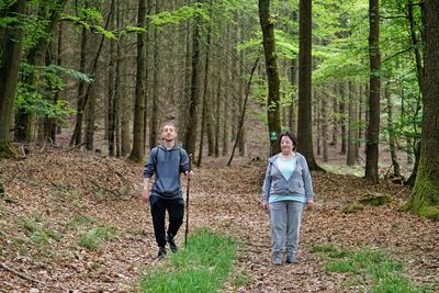 People walking on footpath in forest